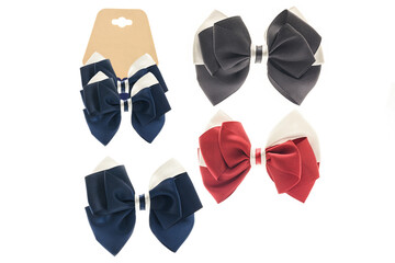 Kit, set of colorful of satin bow hair for girl, woman isolated on white background. Scrunchie hair clip accessory for girls and women. Red, blue, black colors. Close up