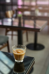 hot coffee on a table with cream being poured into it showing the texture