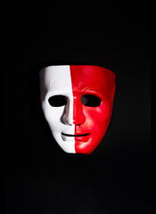Creatively painted human face mask, creative arrangement against dark background, Two sides...