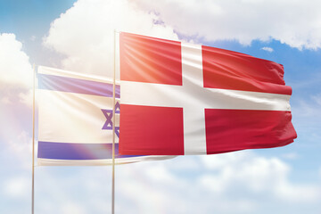 Sunny blue sky and flags of denmark and israel