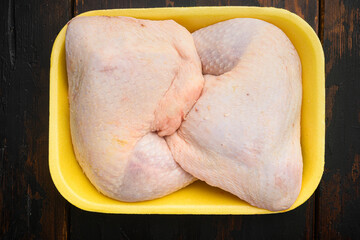 Fresh Chicken Whole Legs, in Foam Tray Pack, on old dark  wooden table, top view flat lay