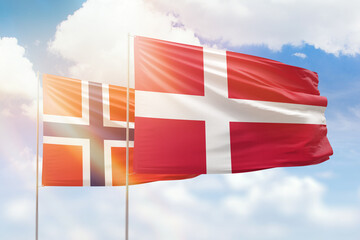 Sunny blue sky and flags of denmark and norway