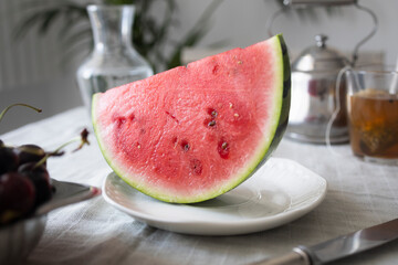Slice of ripe watermelon on a plate on the table Healthy summer dessert or breakfast