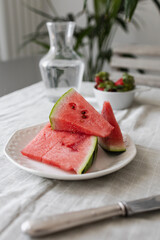 Slice of ripe watermelon on a plate on the table Healthy summer dessert or breakfast