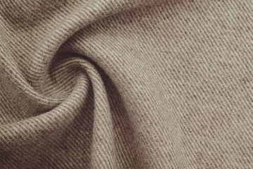 Behangcirkel Texture of twisted dense material of brown color. Piece of fabric with waves for tailoring © Vadzim