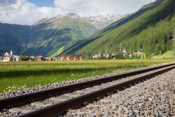 Mountain landscape with the rail tracks of train in Swiss Alps.