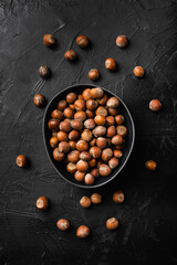 Hazelnut nut health organic brown filbert, on black dark stone table background, top view flat lay