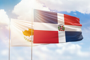 Sunny blue sky and flags of dominican republic and cyprus