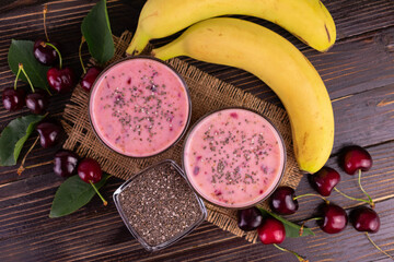 Smoothie with cherry banana and chia seeds on a wooden background.Flet ley.  © Olivka888