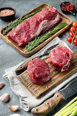 Raw fresh marbled meat Black Angus, Filet mignon tenderloin cut, on wooden cutting board, on gray...