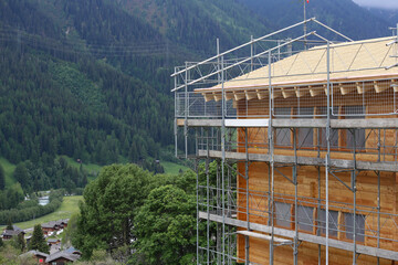 Residential construction site on a hill surrounded by mountains