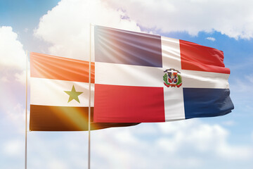 Sunny blue sky and flags of dominican republic and syria