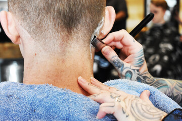 Straight razor being used in barbershop