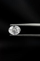 Oval shape diamond with tweezers
