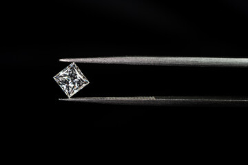 Princess cut diamond with tweezers