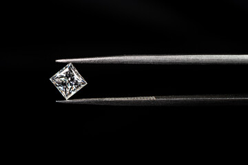 Princess cut diamond with tweezers