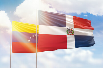 Sunny blue sky and flags of dominican republic and venezuela