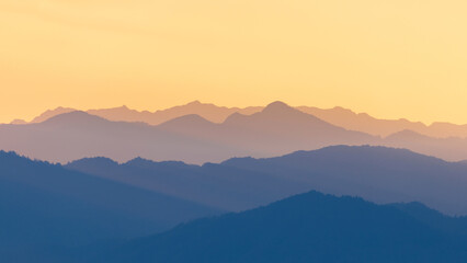 Fototapeta na wymiar Colorful mountain range of tropical rainforest and sky at sunset.
