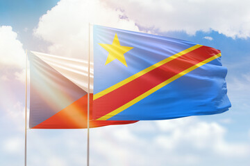 Sunny blue sky and flags of dr congo and czechia