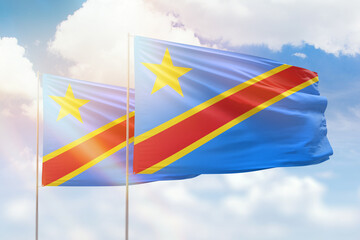 Sunny blue sky and flags of dr congo and dr congo