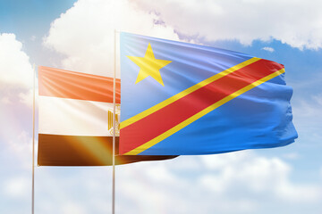 Sunny blue sky and flags of dr congo and egypt