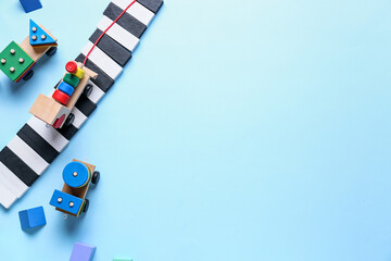 Fototapeta na wymiar Toy train with building blocks on blue background