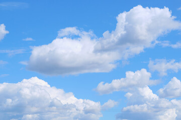 Naklejka na ściany i meble lush white clouds in the blue sky