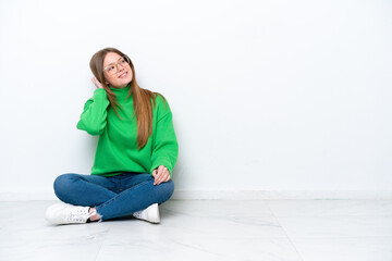 Young caucasian woman sitting on the floor isolated on white background thinking an idea