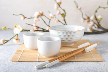 Chinese bowls and chopsticks on light background
