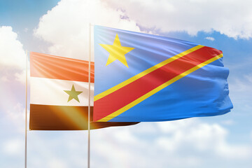 Sunny blue sky and flags of dr congo and syria