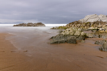 NORTH BEACH WITH LOW TIDE AND CLOUDY SPRING SKY