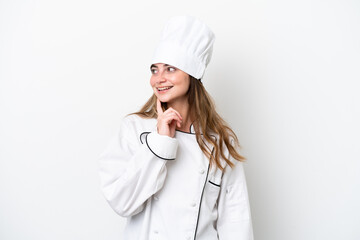 Young caucasian chef woman isolated on white background thinking an idea while looking up