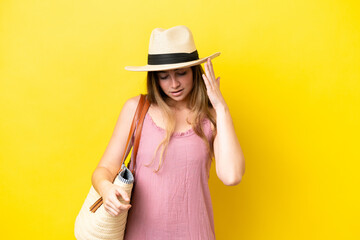 Young caucasian woman holding a beach bag isolated on yellow background with headache