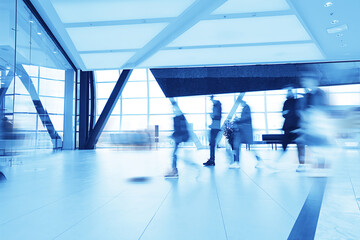 blue background blurred movement of people shopping mall
