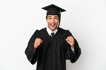 Young university graduate over isolated white background celebrating a victory in winner position