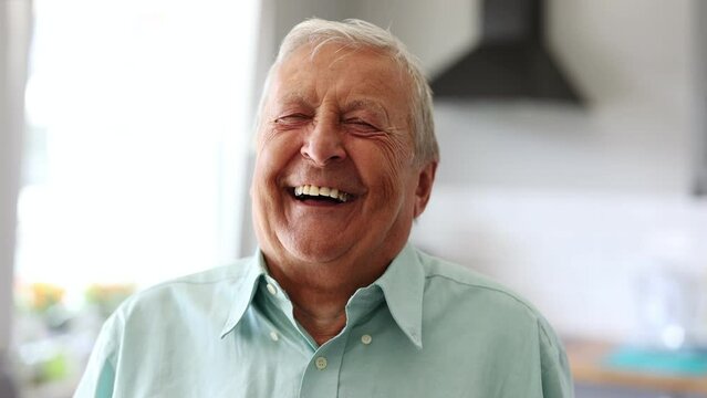 Happy senior man laughing in his home

