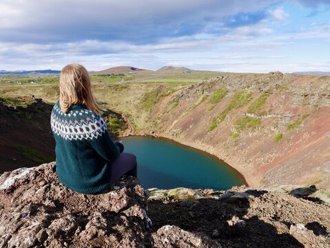 Woman In Icelandic Wool Sweater Looking At Kerid Crater, Iceland.