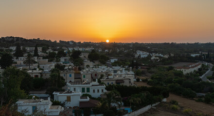 Sunset over the roofs of houses in Protaras, Cyprus