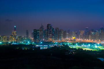 View of the skyline by Dubai Marina, Jumeirah lake towers and the Media City with golf field in the foreground