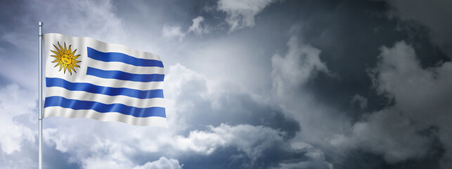 Obraz premium Uruguaian flag on a cloudy sky