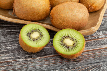 sliced kiwi on wood background