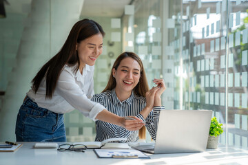 Analysis, Discussion, Asian woman economist and marketer pointing to a financial data sheet to plan, Negotiation