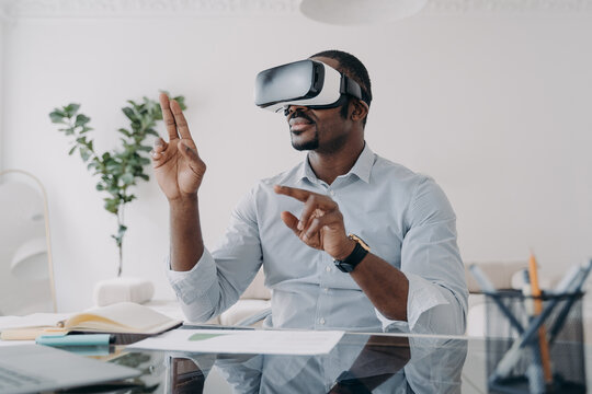 Businessman in vr headset clicks virtual buttons. Modern technology for business and creativity.