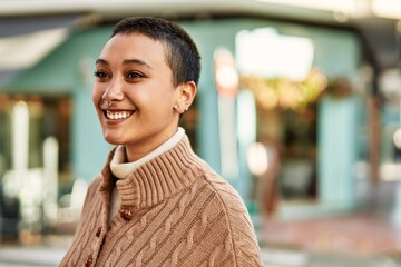 Beautiful hispanic woman with short hair smiling happy outdoors