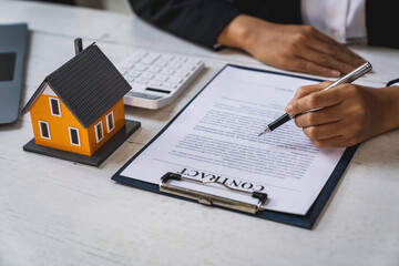Real estate agent working sign agreement document contract for home loan insurance approving...