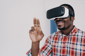 Naklejka premium African american man in virtual reality glasses, interact with cyberspace, play online video game