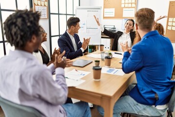 Obraz premium Group of business workers smiling and clapping to partner at the office.