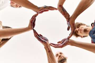 Group of young friends doing circle symbol with hands together