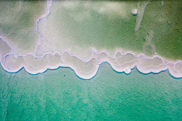 Israeli coast of the Dead Sea. salt mushroom  crystals formations, clear cyan green calm water...