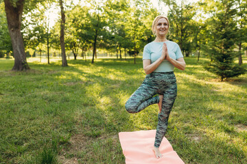 Senior woman doing yoga in park The concept of a healthy lifestyle